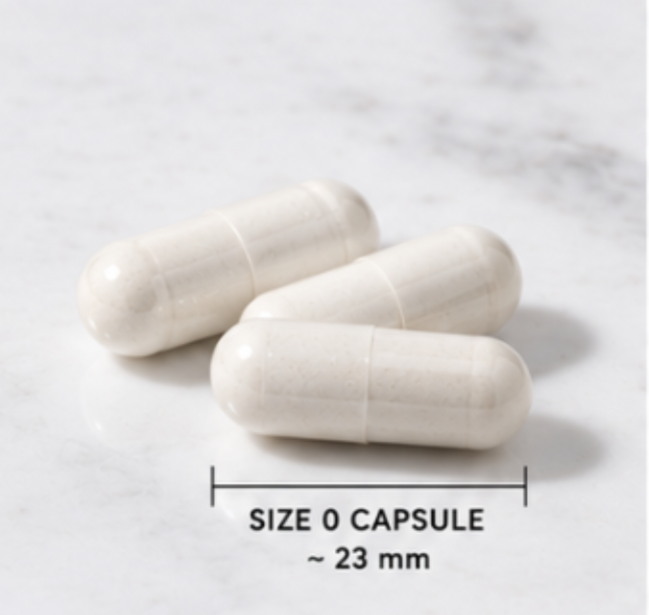 Three off-white size 0 capsules arranged on a light marble surface with a measurement overlay reading 'SIZE 0 CAPSULE ~ 23 mm'.